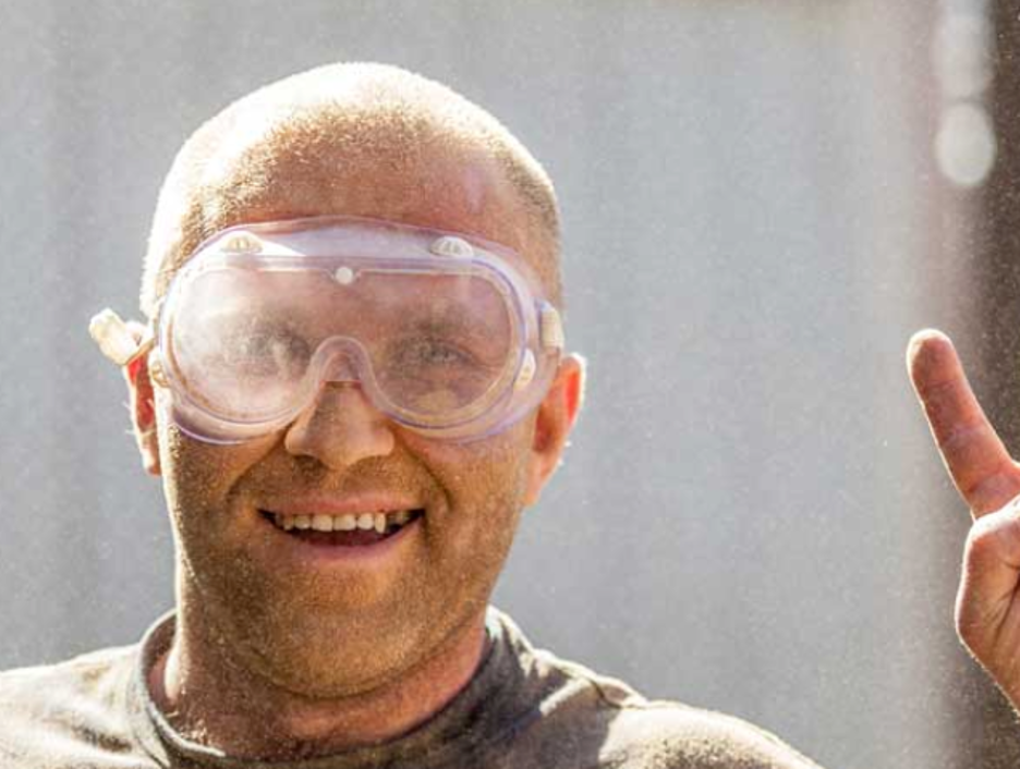 smiling man in safety glasses